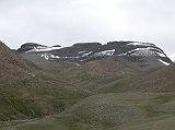 Tibet Kailash 09 Kora 15 Kailash Eastern Face in Clouds About 30 minutes from the end of the descent from the Dolma La, a valley comes down from the Khando Sanglam La to join the main trail. This valley provides the only glimpse of Kailashs eastern or crystal face  alas again in the clouds.